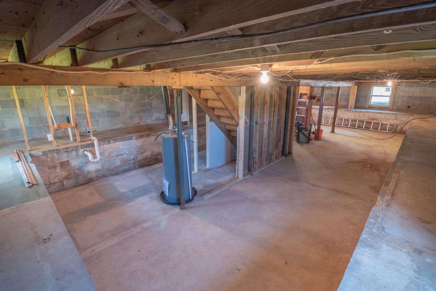 Unfinished basement interior used to illustrate basement waterproofing work