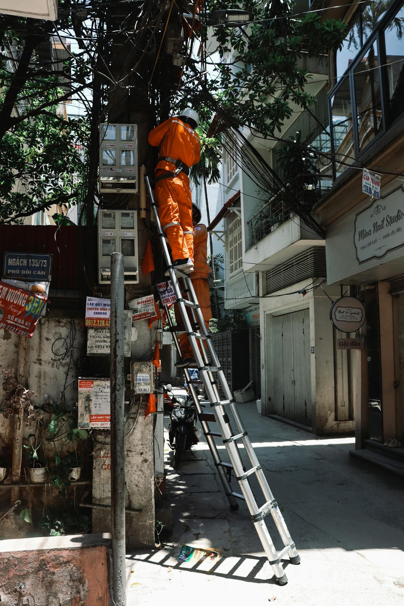 Electrician performing electrical repair work on building wiring